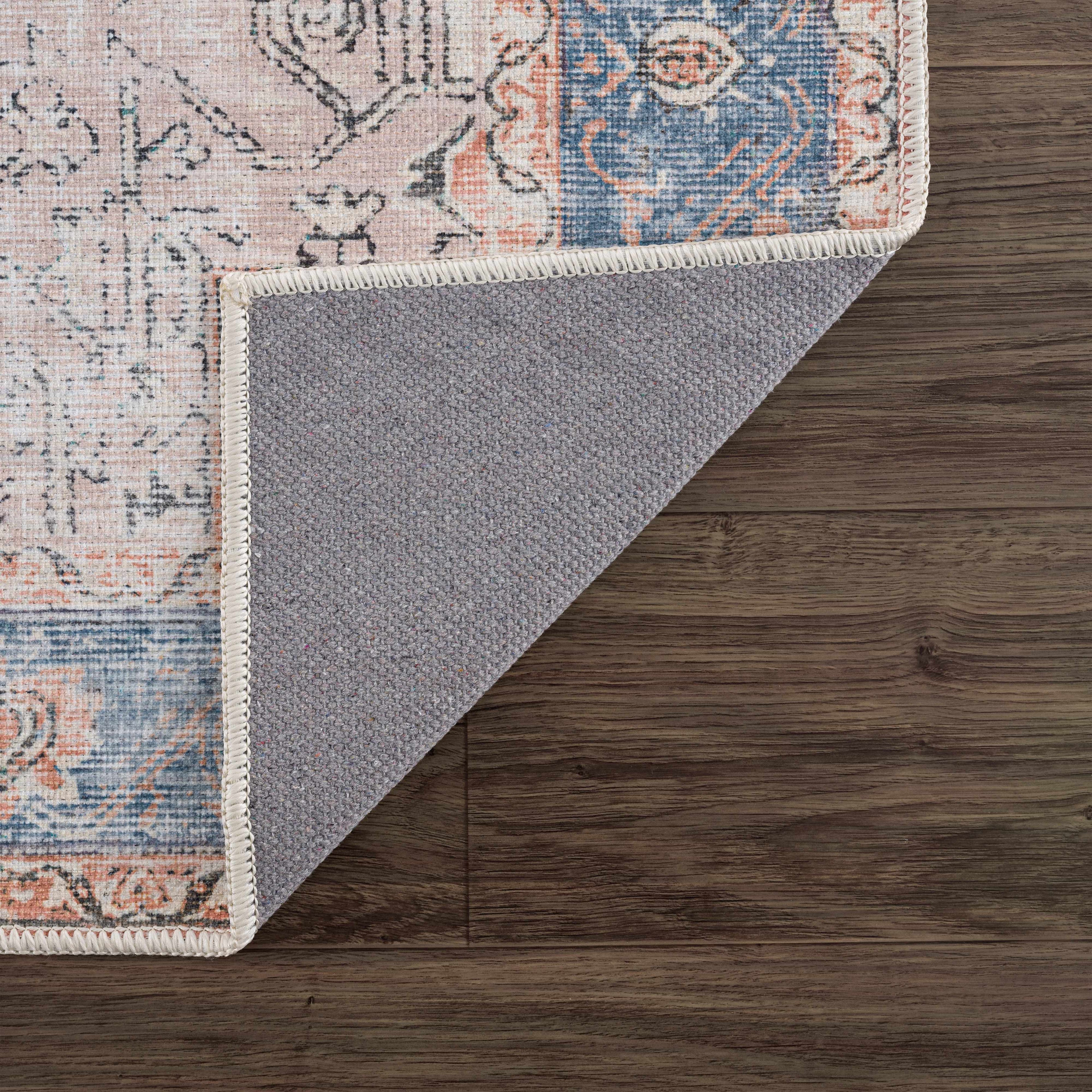 Rosman distressed flat weave area rug in warm red, blue, and earthy tones with vintage-inspired pattern