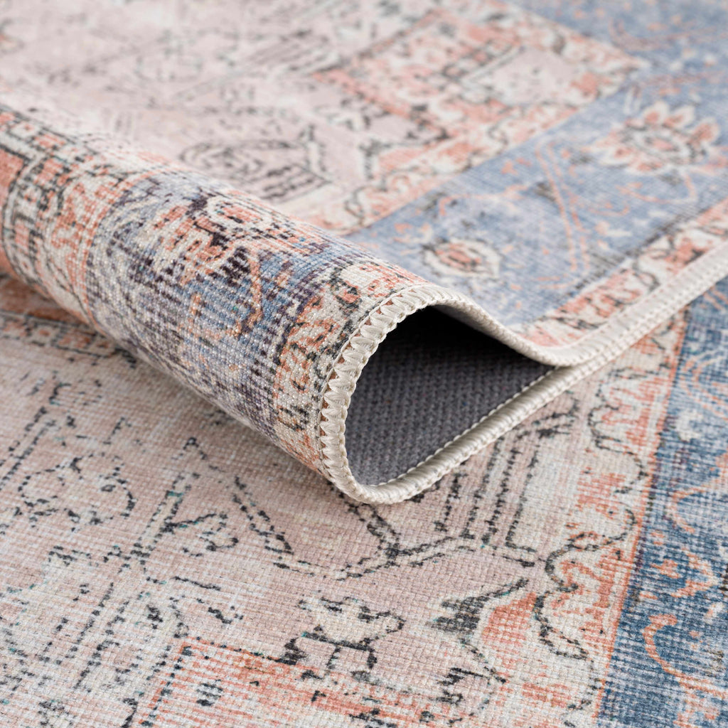 Rosman distressed flat weave area rug in warm red, blue, and earthy tones with vintage-inspired pattern