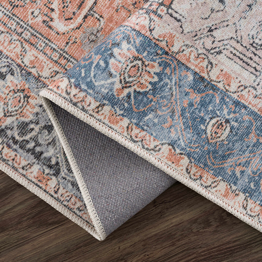 Rosman distressed flat weave area rug in warm red, blue, and earthy tones with vintage-inspired pattern