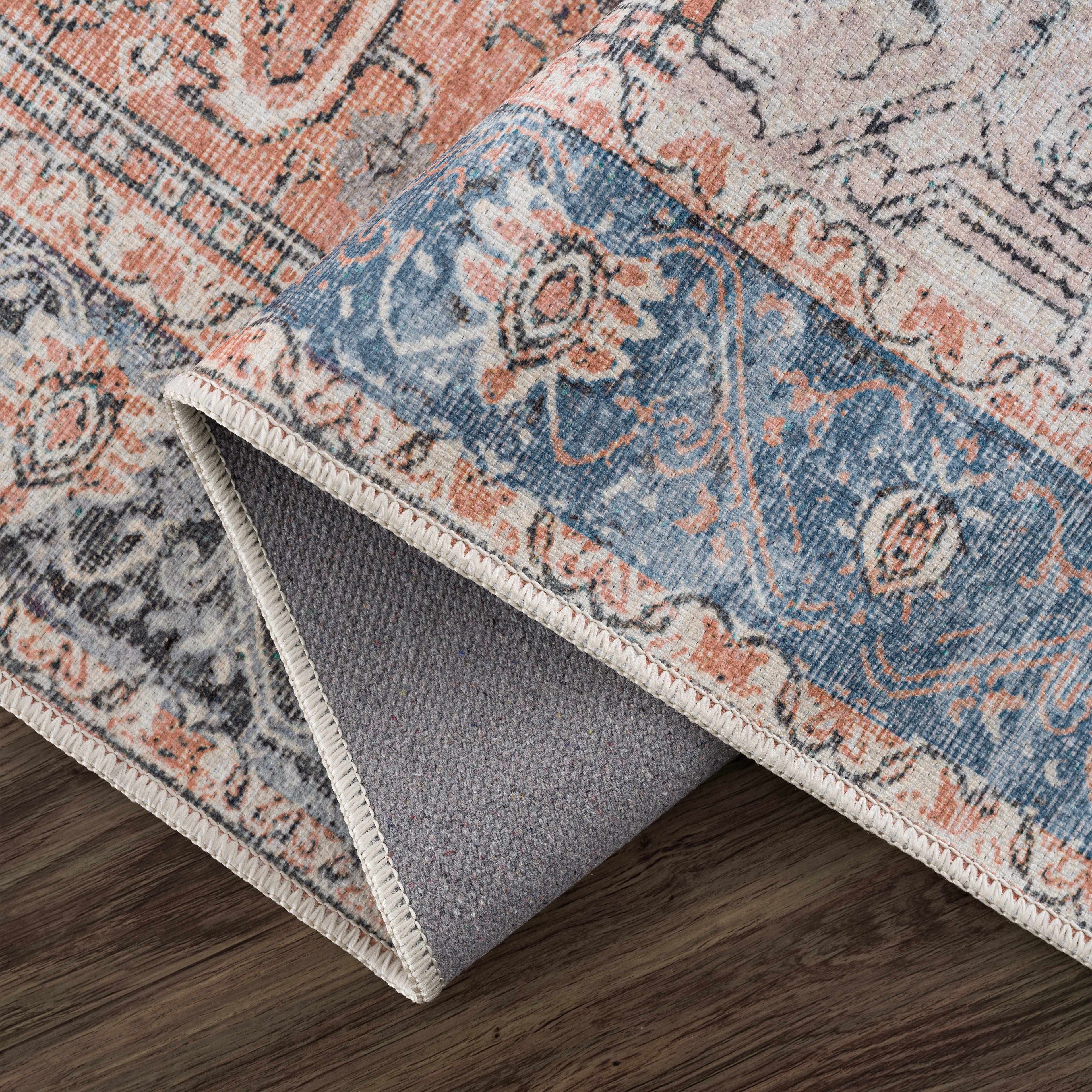Rosman distressed flat weave area rug in warm red, blue, and earthy tones with vintage-inspired pattern