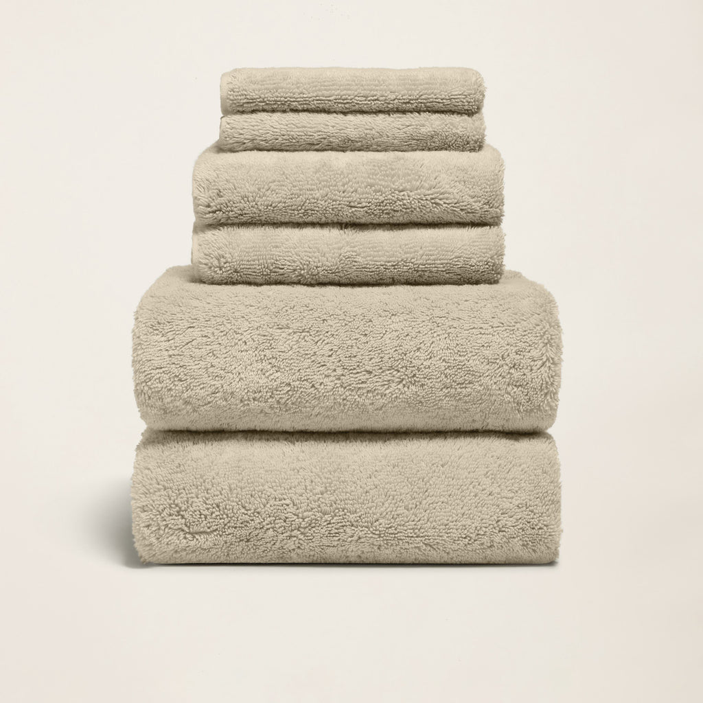 Stack of folded thick white 800 GSM Australian cotton bath towels showing dense plush loop texture