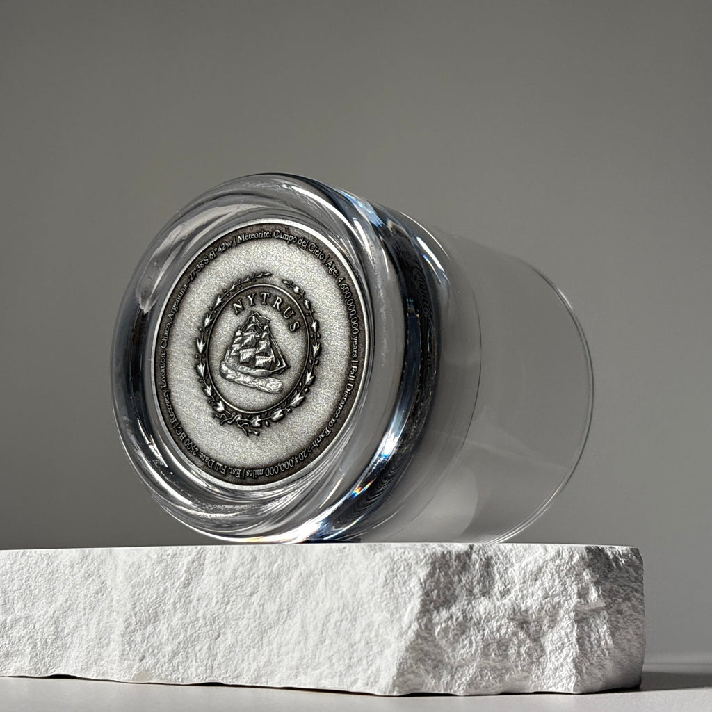 Set of two glass tumblers with genuine meteorite fragments suspended in high-clarity bases, shown in Antique Tin and Amber Gold finishes