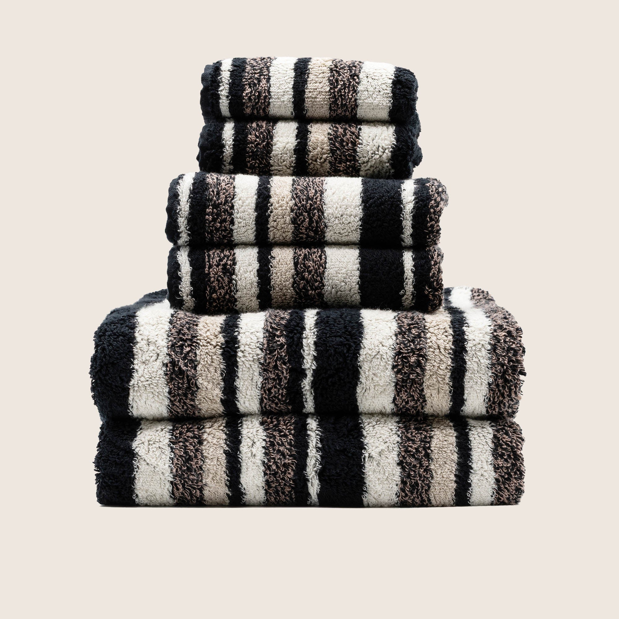 Stack of folded thick white 800 GSM Australian cotton bath towels showing dense plush loop texture