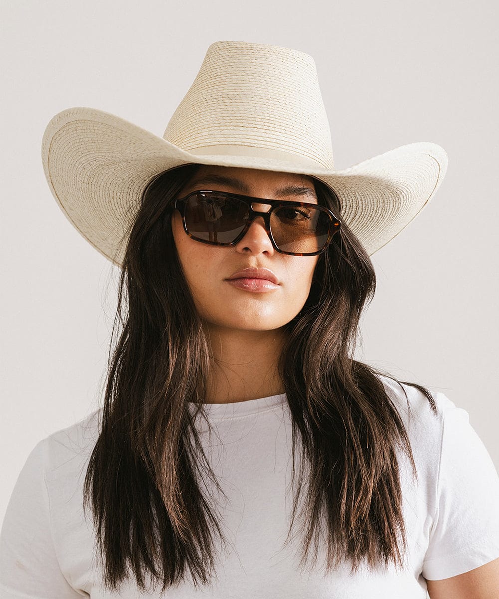 Men's rectangular vintage-inspired aviator sunglasses with light lenses and a gold-tone frame, shown with leather storage case
