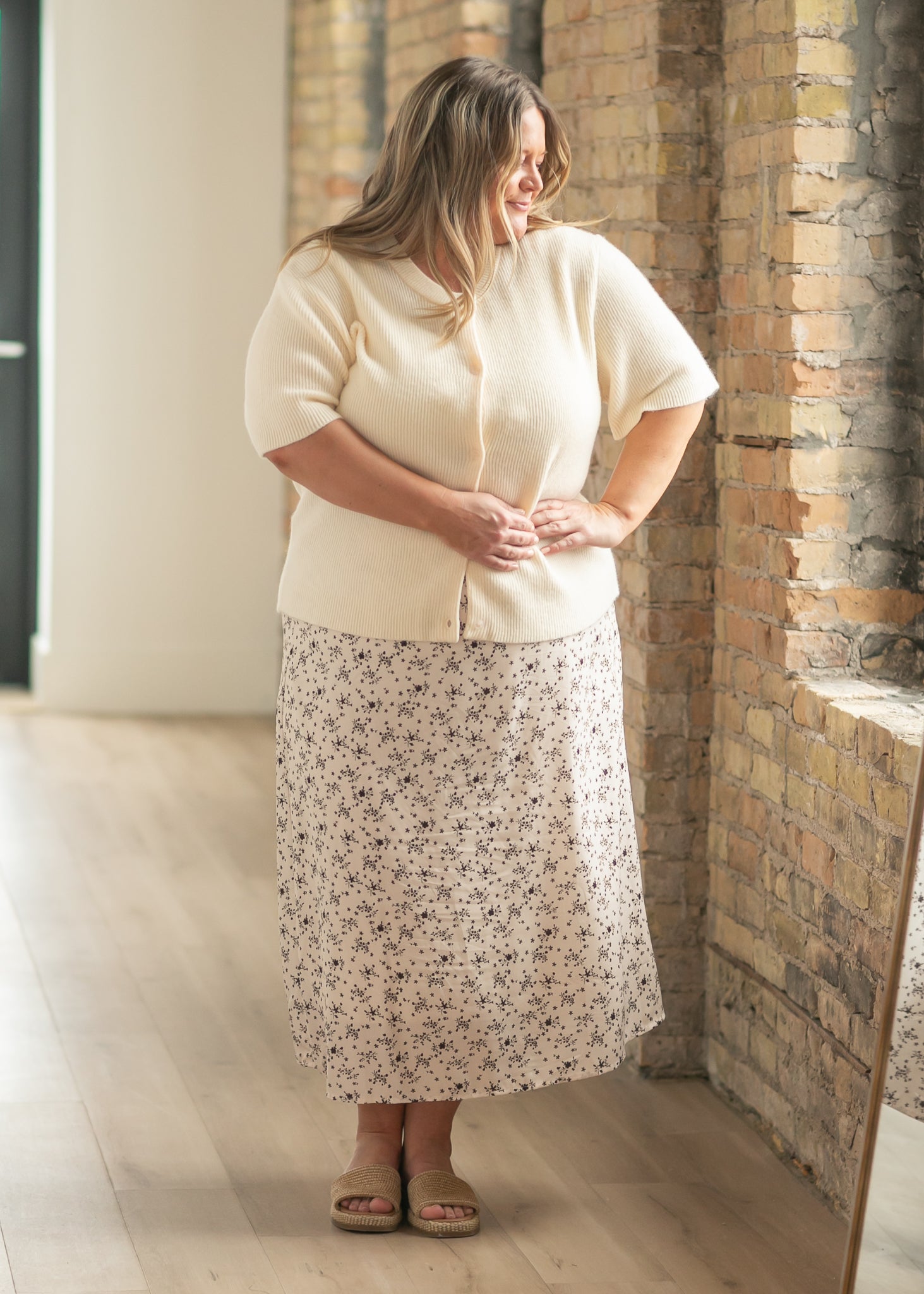Oversized ivory short-sleeve button cardigan in soft cotton-rayon knit with vertical texture and crew neckline